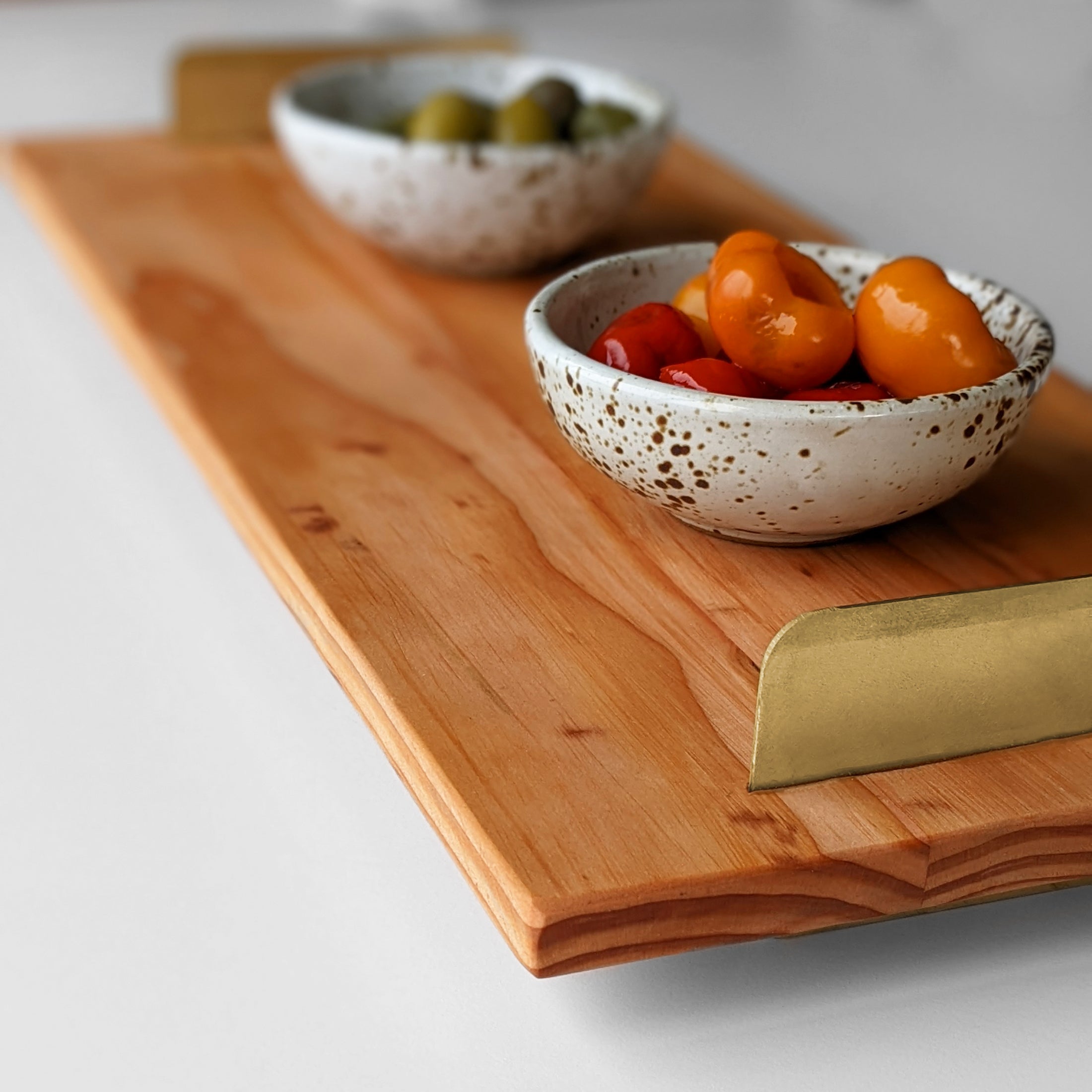 A beautifully crafted Brass Handle Tray made from Doug Fir wood with elegant brass handles, showcasing a unique beeswax finish.