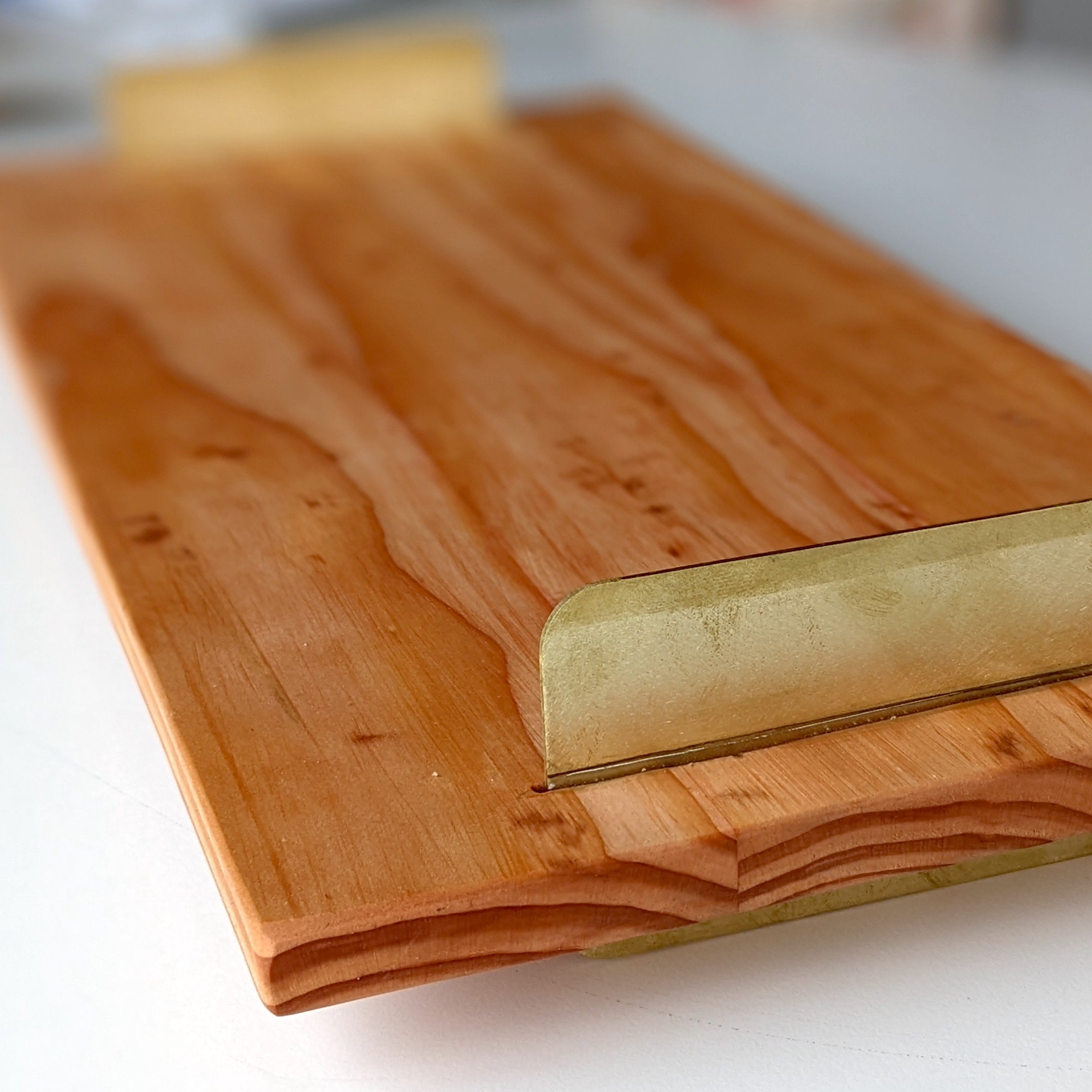 A beautifully crafted Brass Handle Tray made from Doug Fir wood with elegant brass handles, showcasing a unique beeswax finish.