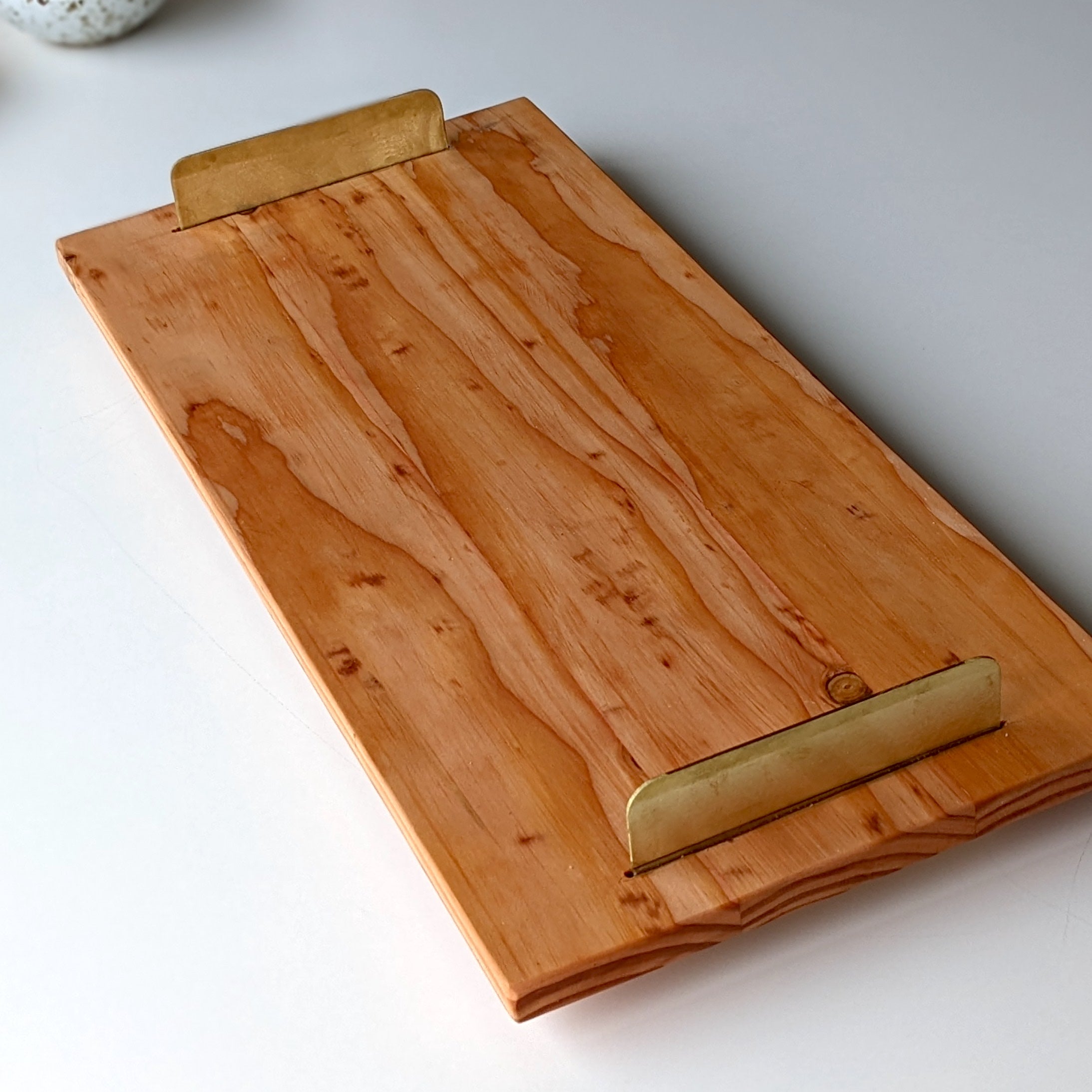 A beautifully crafted Brass Handle Tray made from Doug Fir wood with elegant brass handles, showcasing a unique beeswax finish.