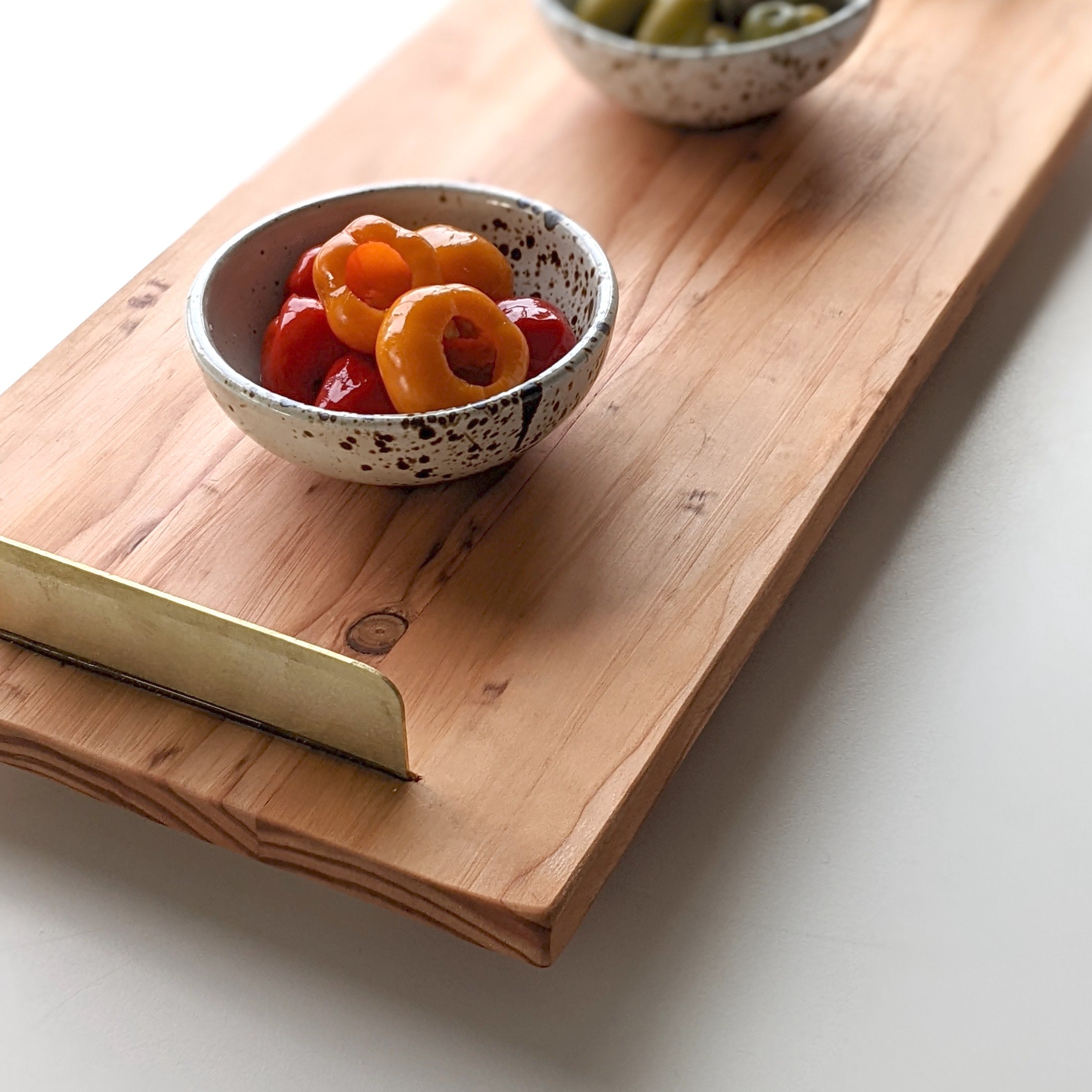 A beautifully crafted Brass Handle Tray made from Doug Fir wood with elegant brass handles, showcasing a unique beeswax finish.