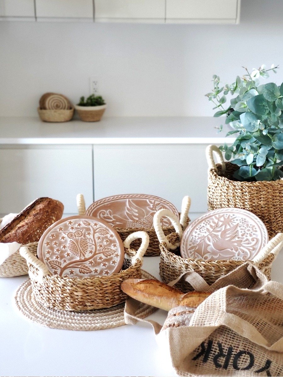 Handcrafted Bird Oval Bread Warmer made of terracotta with a seagrass basket, featuring intricate bird and leaf designs.