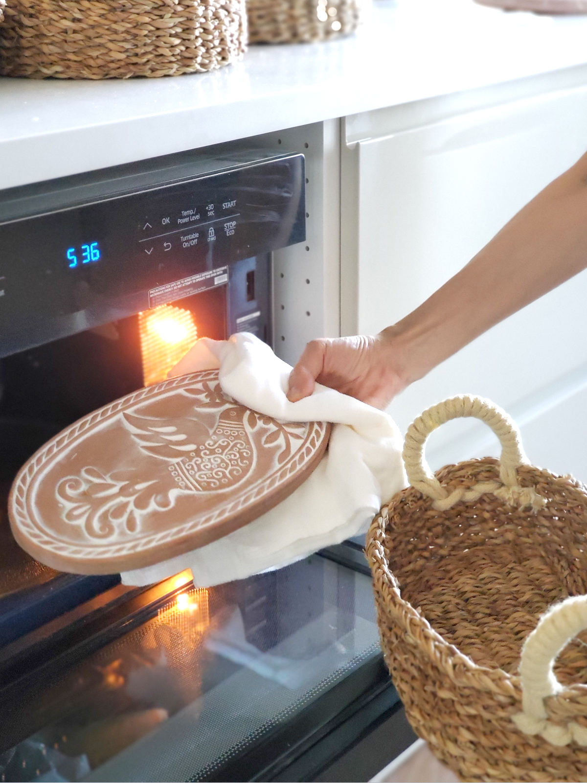 Handcrafted Bird Oval Bread Warmer made of terracotta with a seagrass basket, featuring intricate bird and leaf designs.