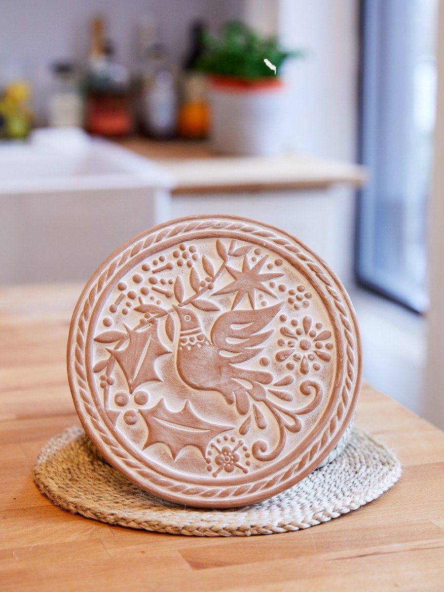 Handcrafted Bird Round Bread Warmer made of terracotta with a seagrass basket, featuring a unique bird engraving.