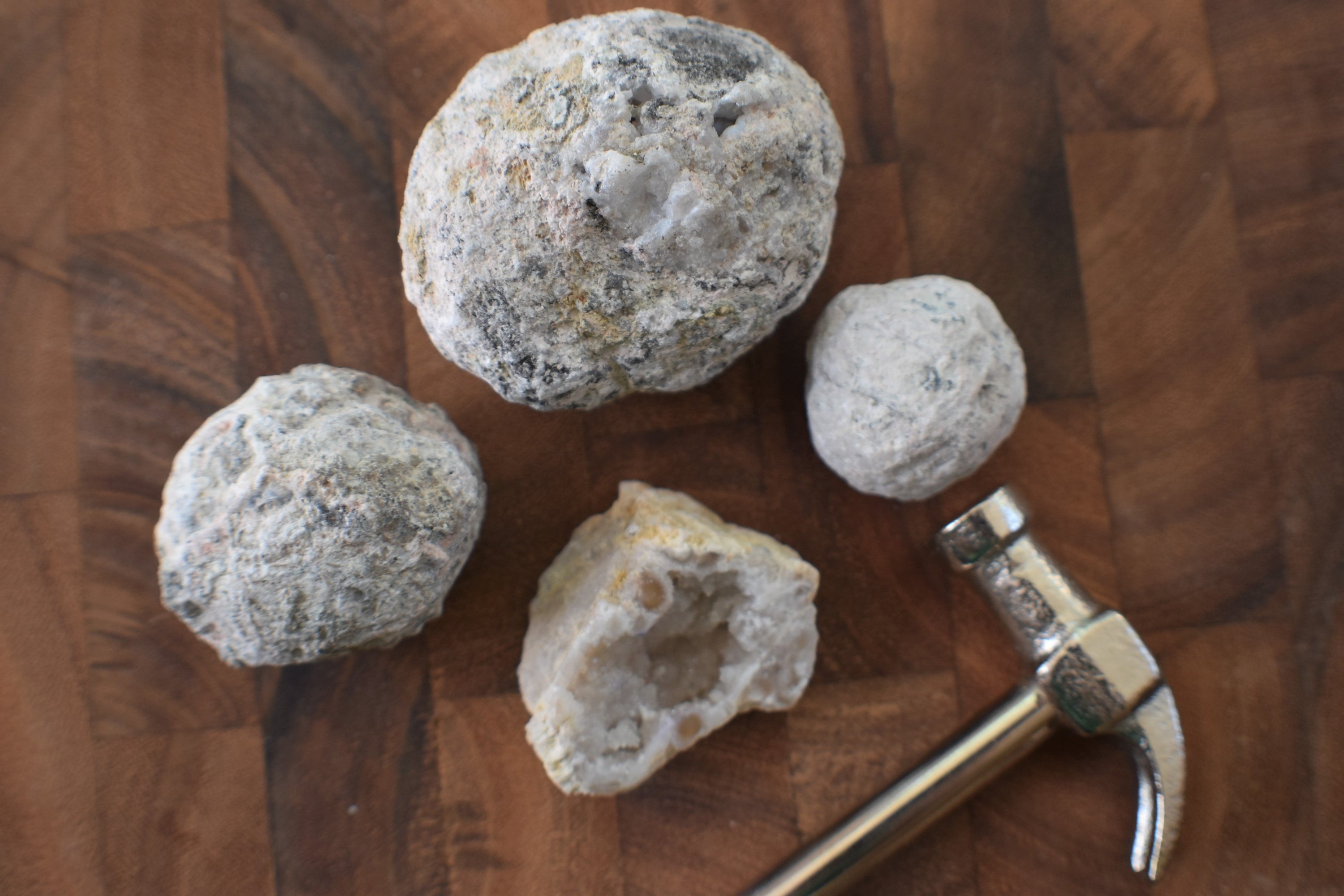 A collection of agate geodes in various sizes, showcasing their spherical shapes and unique textures, ready to be cracked open for exploration.