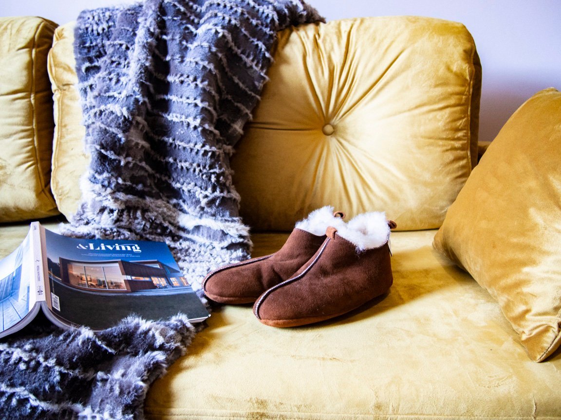 Elegant brown leather slippers with natural fur lining, designed for comfort and durability.