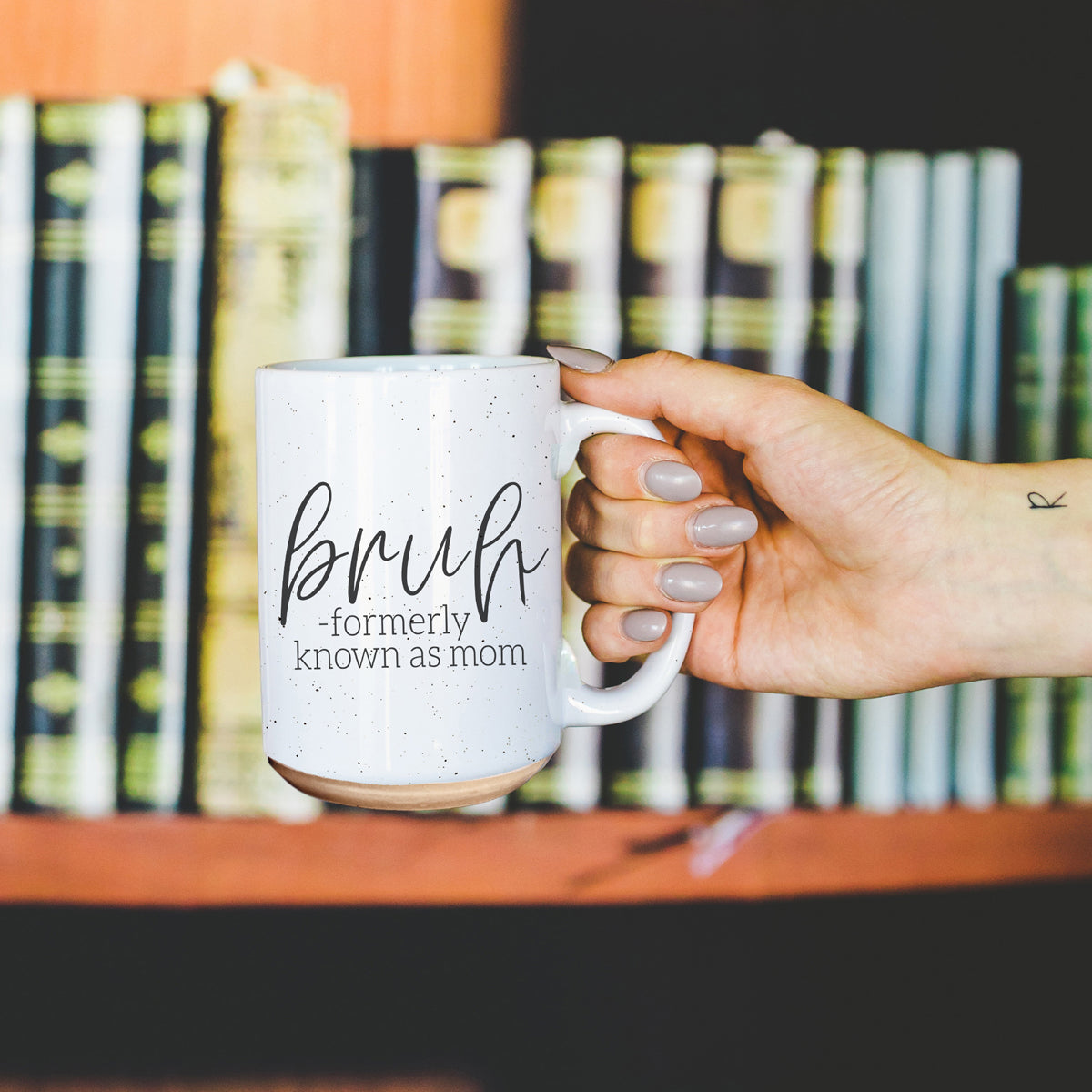 Bruh 16oz ceramic mug with humorous graphic design, off white color with dark speckles, perfect for coffee or tea.