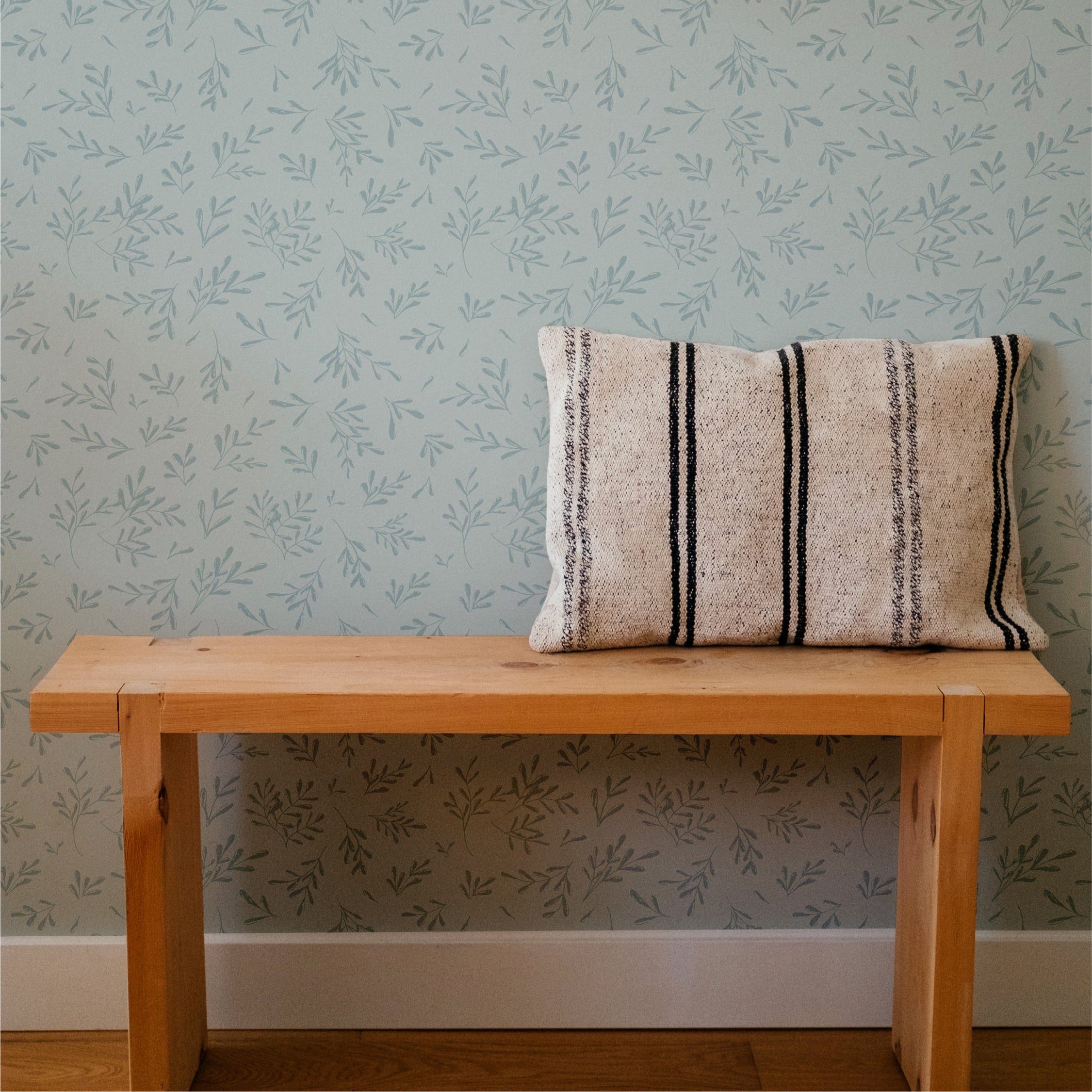 Brushed Leaves (Blue) wallpaper featuring a modern design with vibrant blue leaves on a light background, perfect for home decor.