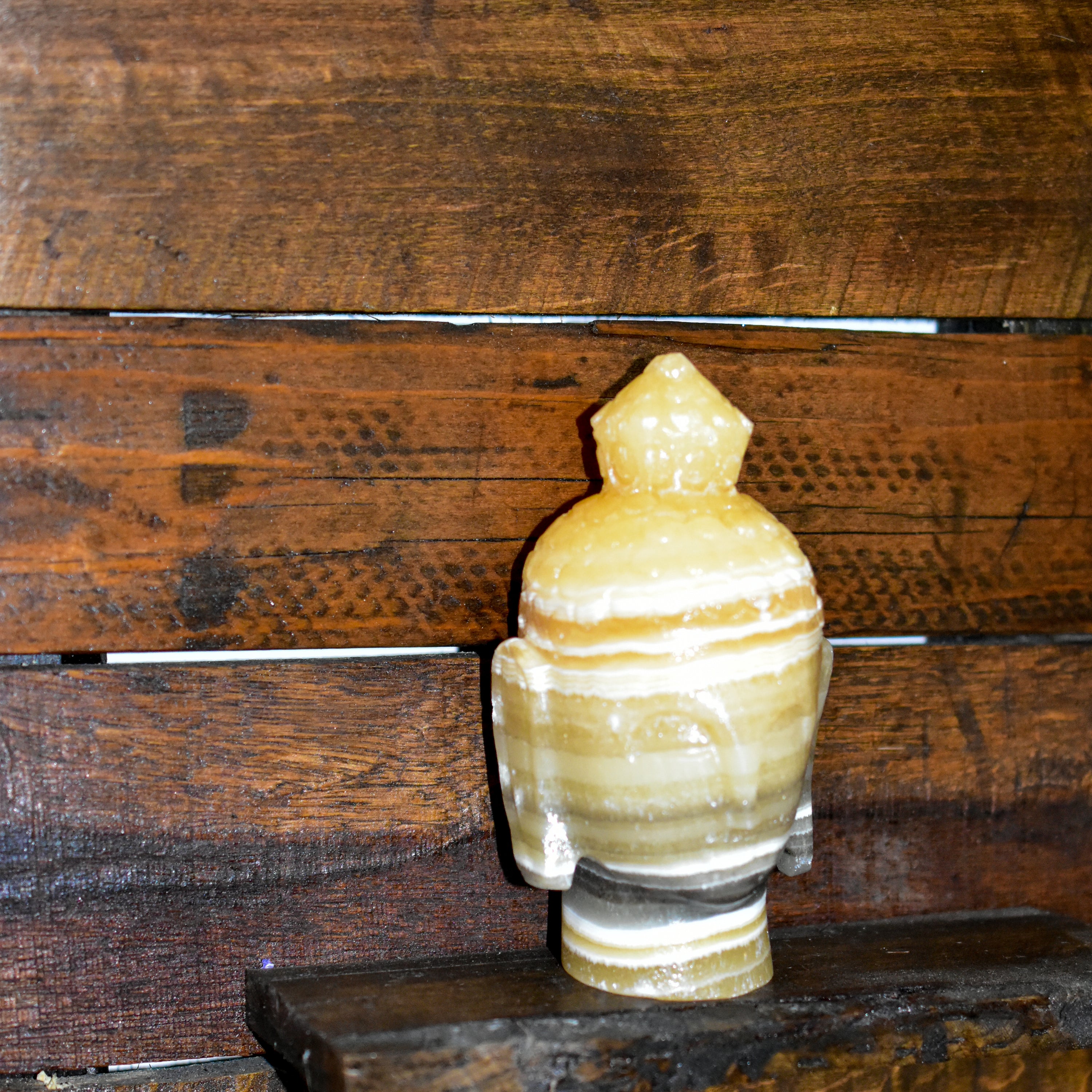 Hand carved Onyx Buddha head decorative accent piece in various colors, showcasing intricate details and craftsmanship.