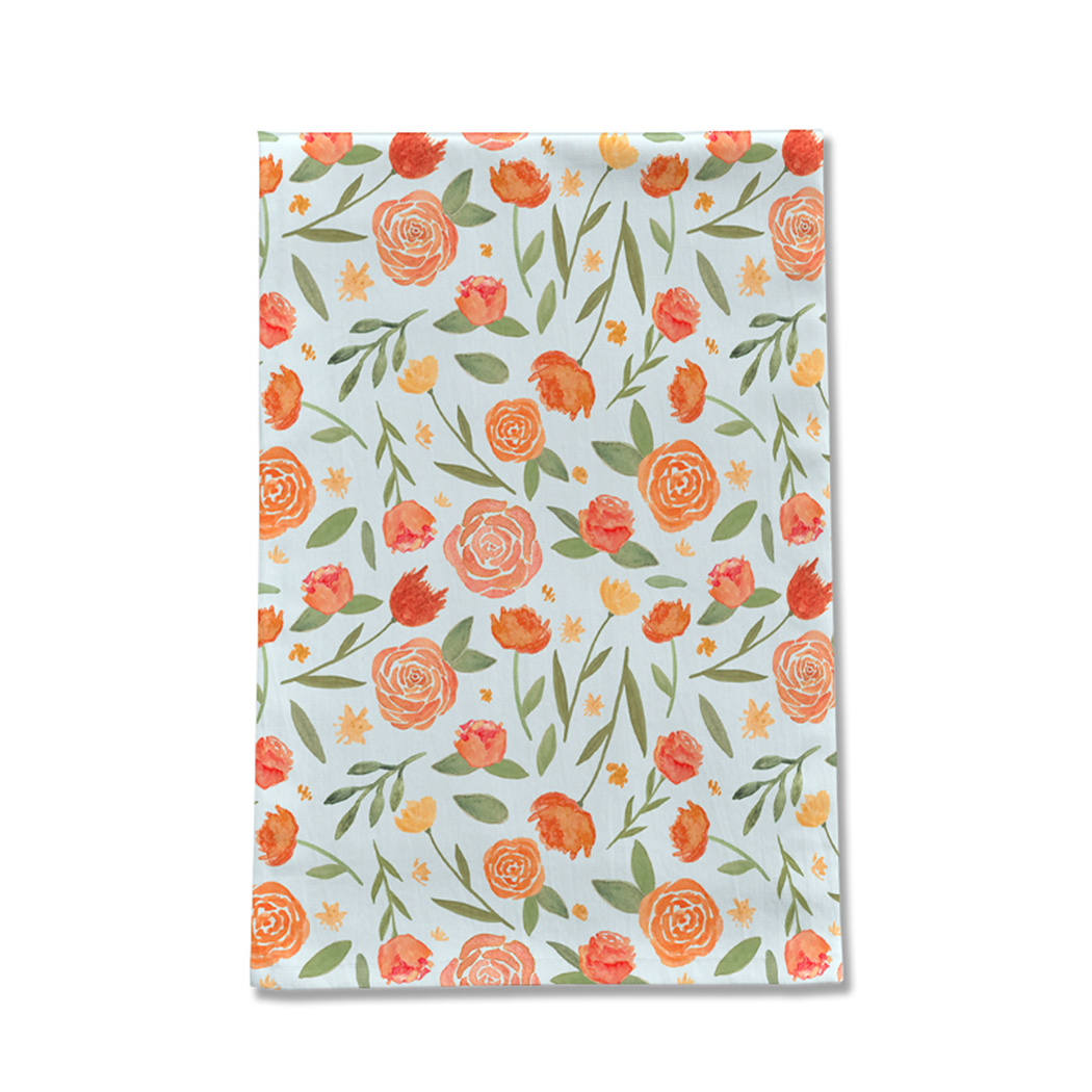 Burnt orange floral tea towel featuring a vibrant floral pattern on a cotton twill fabric, perfect for kitchen use.