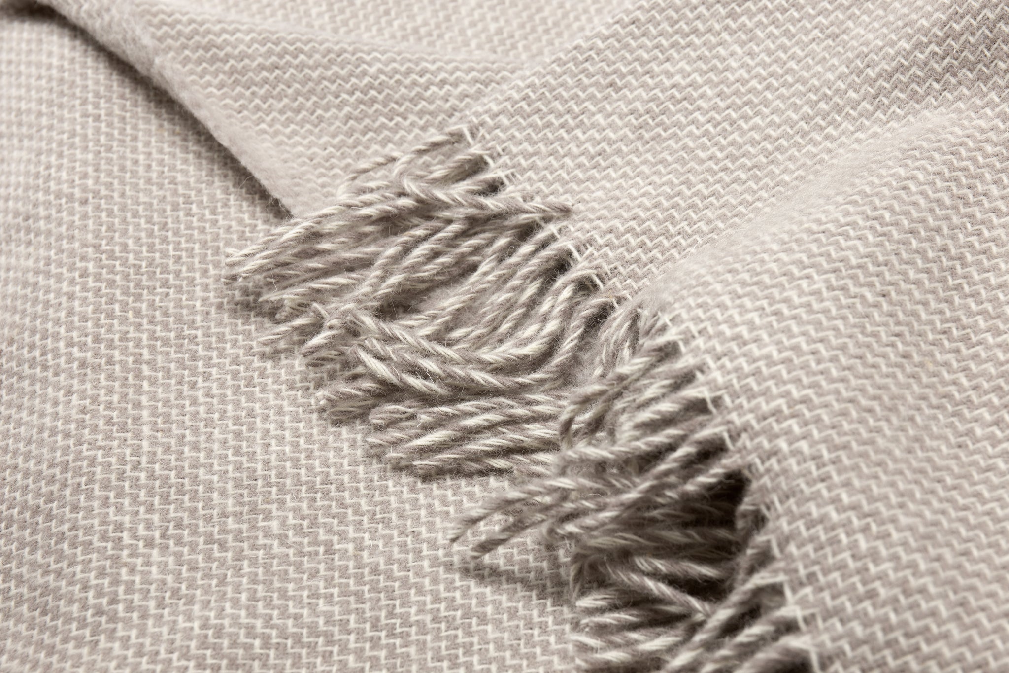 Cambridge Throw blanket made from 100% New Zealand wool in silver color, showcasing its thick and cozy texture.