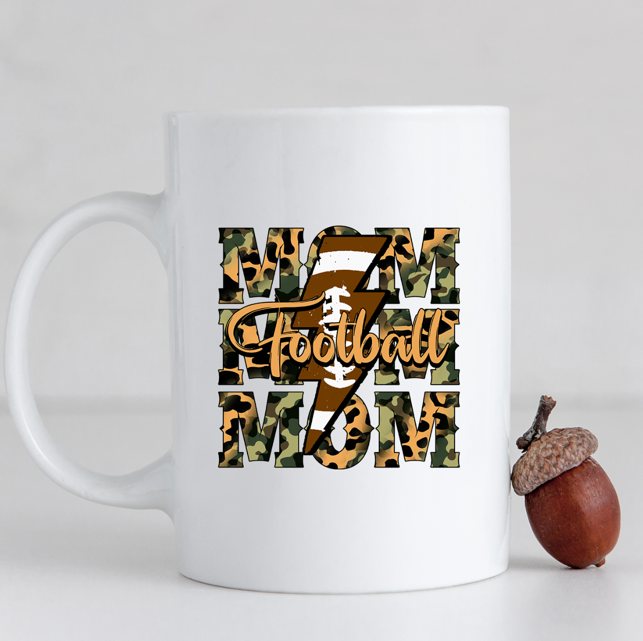 Camo Football Mom 15oz Mug featuring a vibrant camo print on a glossy white ceramic surface.