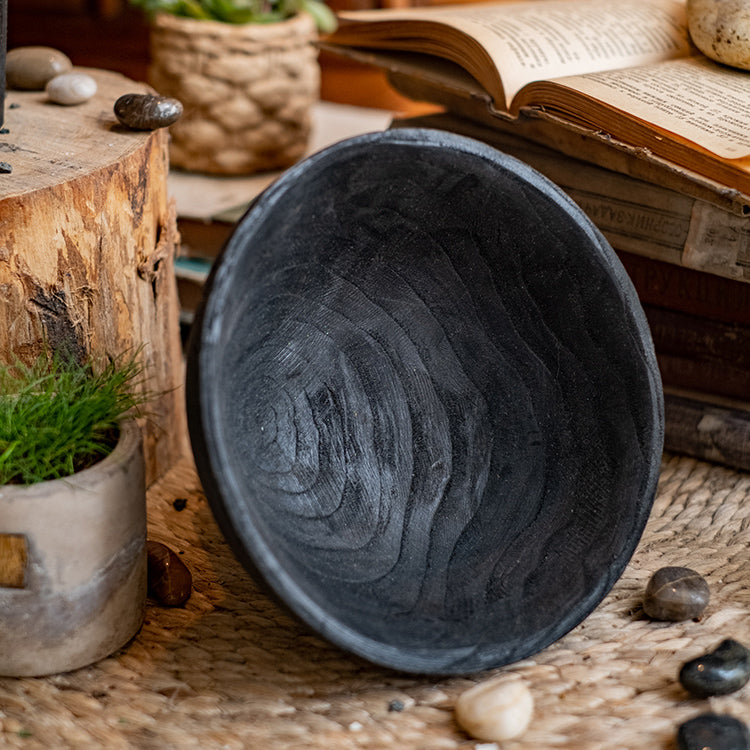 A stylish Carbonized Wood Footed Bowl with a fluted pedestal, showcasing a smoky charcoal color and intricate wood grain patterns.