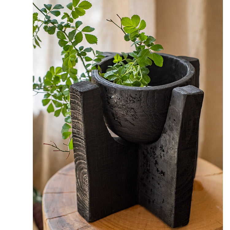 Carbonized wood plant bowl with stand, featuring a dark ashen black finish and minimalist design, ideal for decorative arrangements.