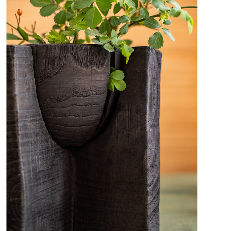 Carbonized wood plant bowl with stand, featuring a dark ashen black finish and minimalist design, ideal for decorative arrangements.