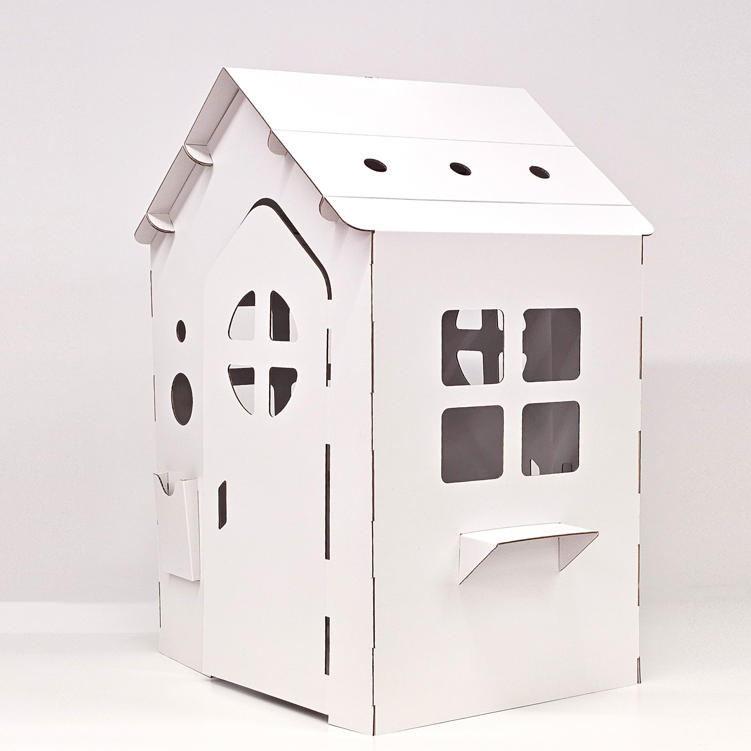 Cardboard playhouse WONDERLAND in white, featuring doors, windows, and a mailbox, designed for children's imaginative play.