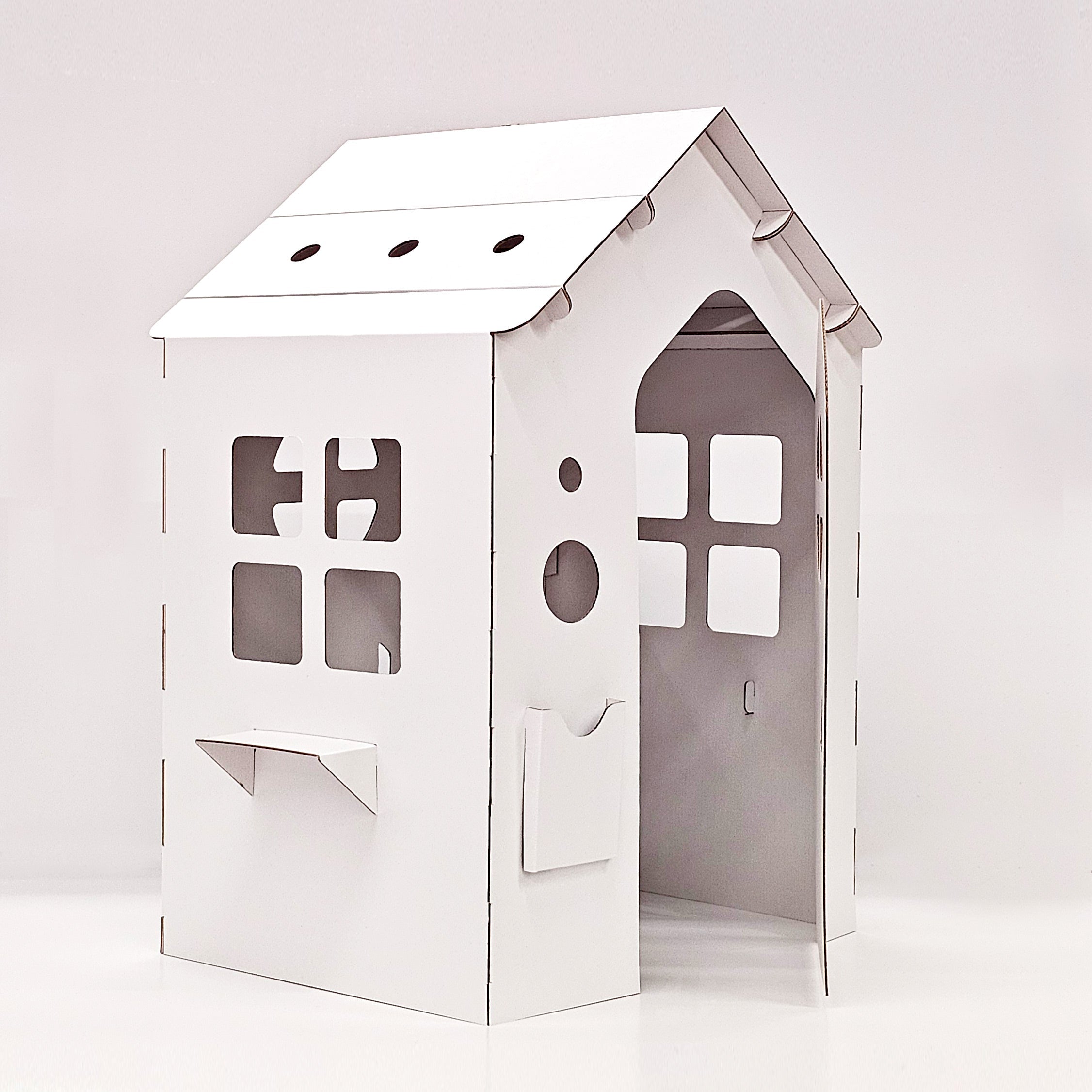 Cardboard playhouse WONDERLAND in white, featuring doors, windows, and a mailbox, designed for children's imaginative play.