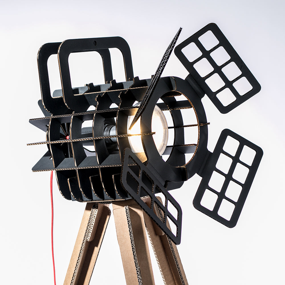 Cardboard Tripod Projector SHOW featuring a stylish design with a spotlight illuminating an object, made from colored corrugated cardboard.