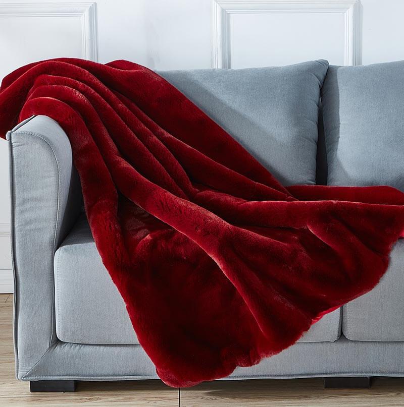 Cassilda Luxury Red Chinchilla Faux Fur Throw Blanket showcasing its plush texture and vibrant red color, perfect for home decor.