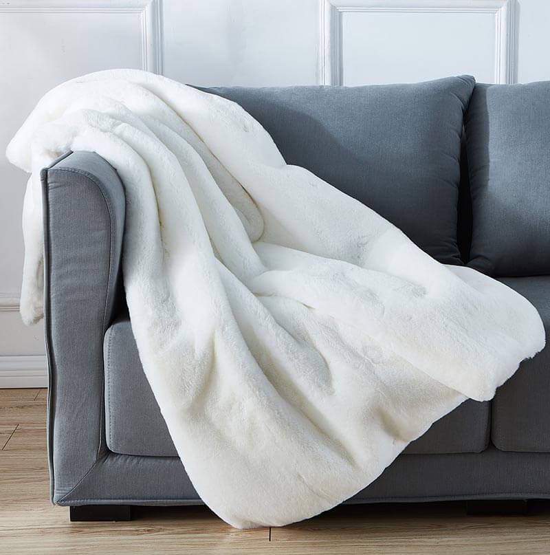 Cassilda Luxury White Chinchilla Faux Fur Throw Blanket showcasing plush texture and elegant design.