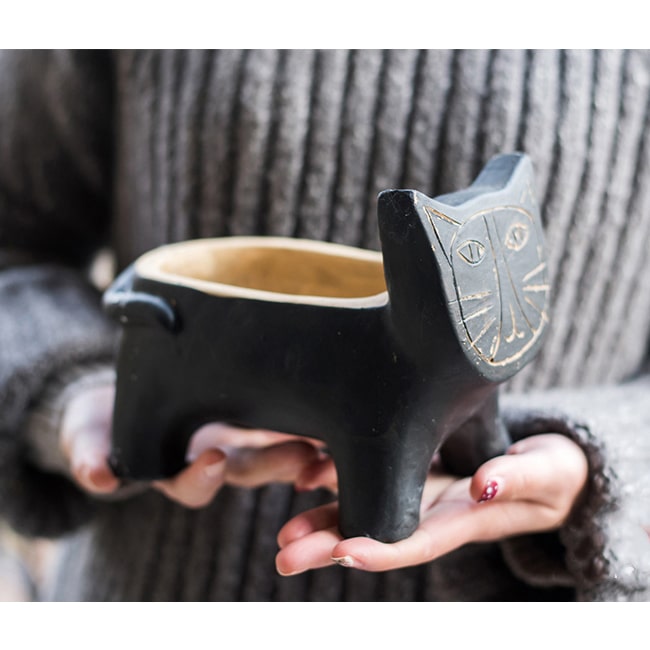 A charming cat-shaped small planter made of concrete, showcasing a unique design in black, khaki, and mixed colors.