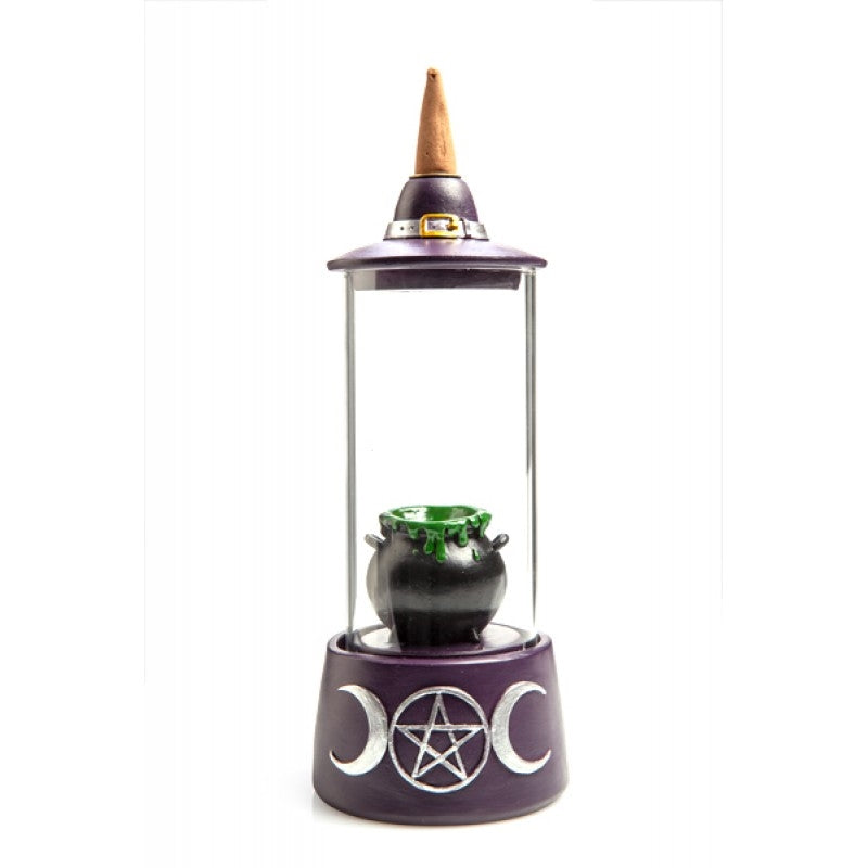 A beautifully crafted Cauldron Glass Case LED Backflow Incense Burner featuring a witch's hat, with colorful LED lights illuminating the flowing smoke.