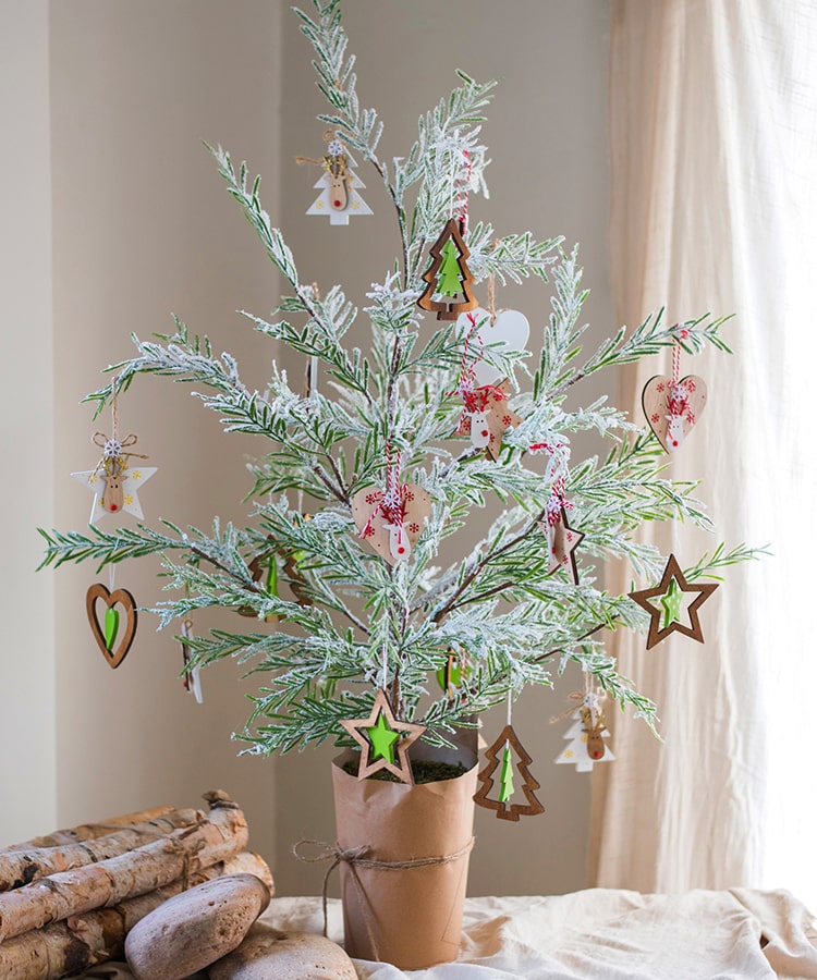 Cedar Fir Tree Snow Flocked Christmas Tree with a paper wrapped base, showcasing realistic snow and green foliage.