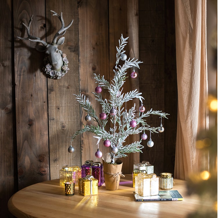 Cedar Fir Tree Snow Flocked Christmas Tree with a paper wrapped base, showcasing realistic snow and green foliage.