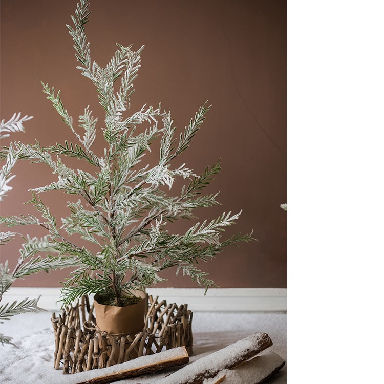 Cedar Fir Tree Snow Flocked Christmas Tree with a paper wrapped base, showcasing realistic snow and green foliage.