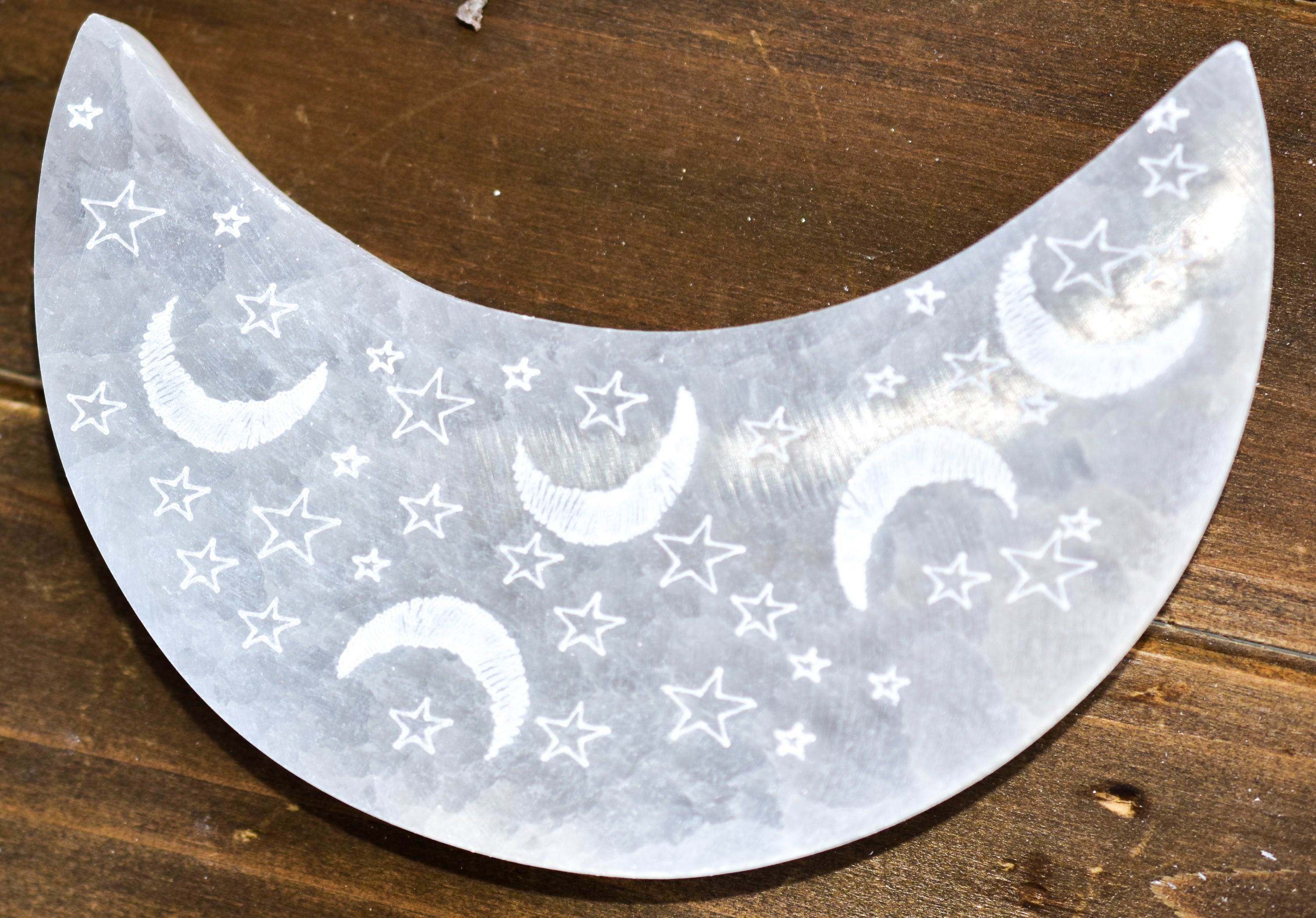 Celestial Engraved Crescent Moon Selenite Plate with intricate moon and star designs, perfect for crystal charging and jewelry display.