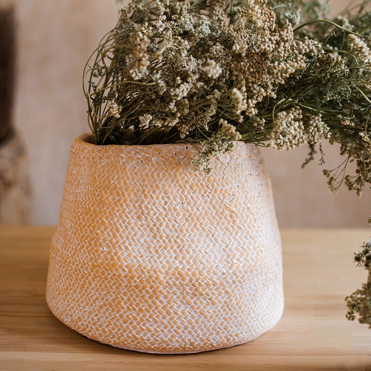 Cement Weaving Pattern Planter in khaki color, showcasing its unique design and drainage hole.