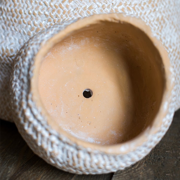 Cement Weaving Pattern Planter in khaki color, showcasing its unique design and drainage hole.