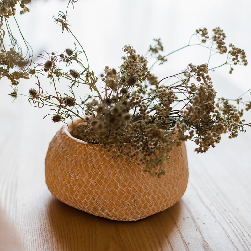 Cement Weaving Pattern Planter in khaki color, showcasing its unique design and drainage hole.