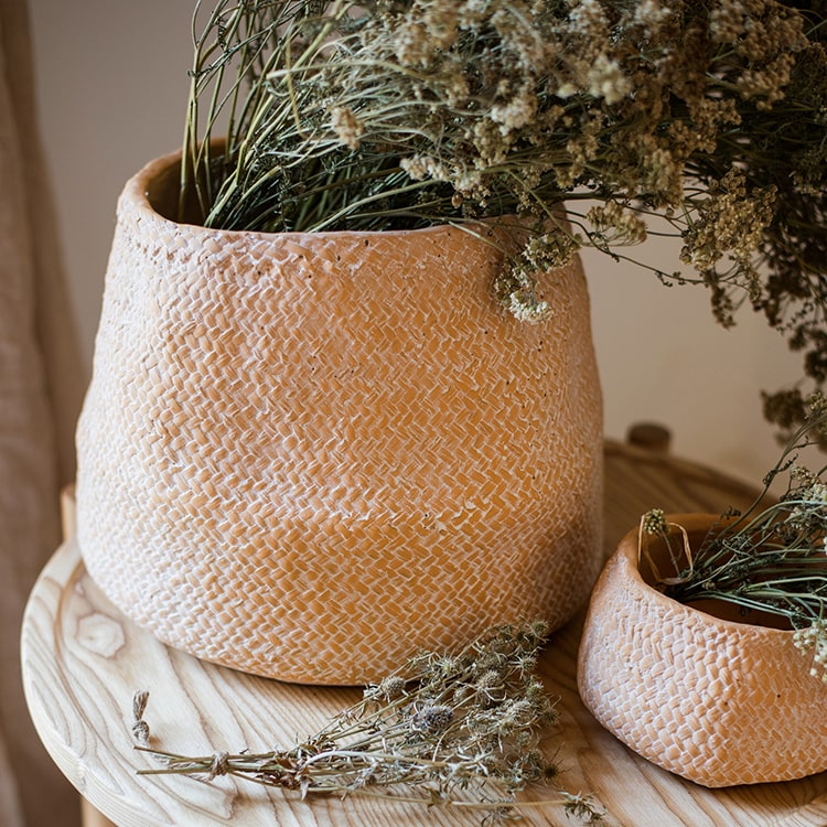 Cement Weaving Pattern Planter in khaki color, showcasing its unique design and drainage hole.