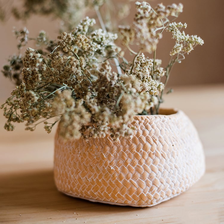 Cement Weaving Pattern Planter in khaki color, showcasing its unique design and drainage hole.