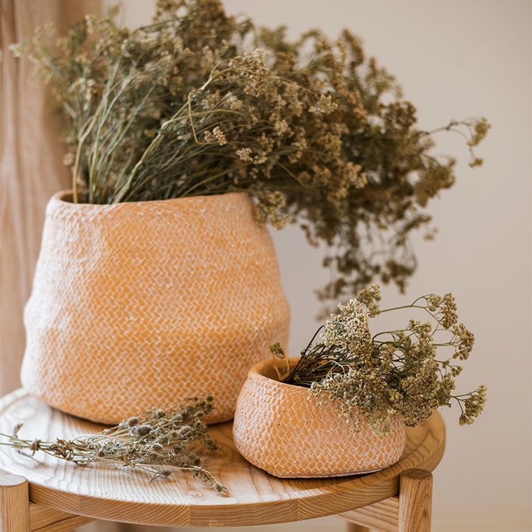 Cement Weaving Pattern Planter in khaki color, showcasing its unique design and drainage hole.