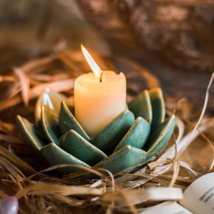 Handmade ceramic floral candle holder in light blue, blue, green, and red colors, showcasing unique designs and dimensions.