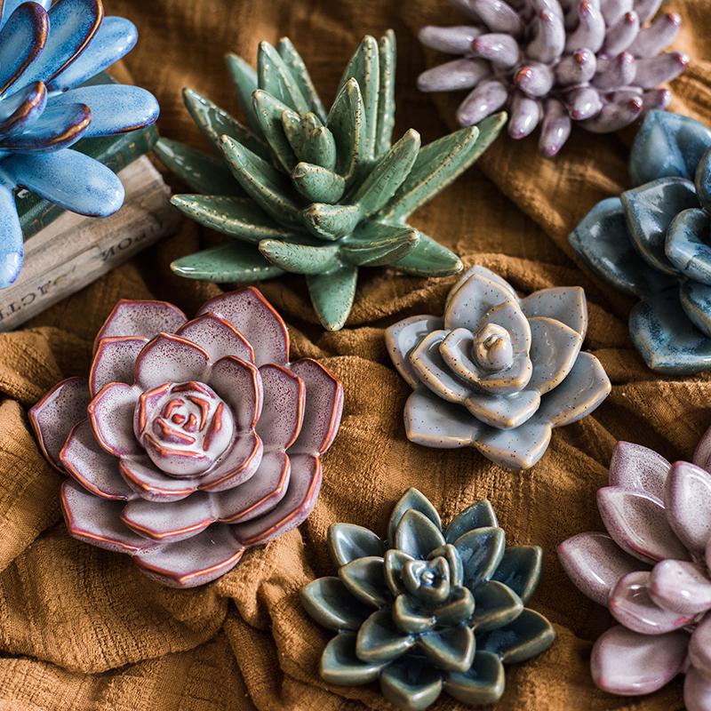 A collection of handmade ceramic floral table accents in various colors and sizes, showcasing their unique designs.