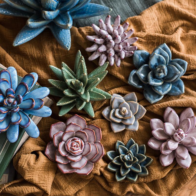 A collection of handmade ceramic floral table accents in various colors and sizes, showcasing their unique designs.