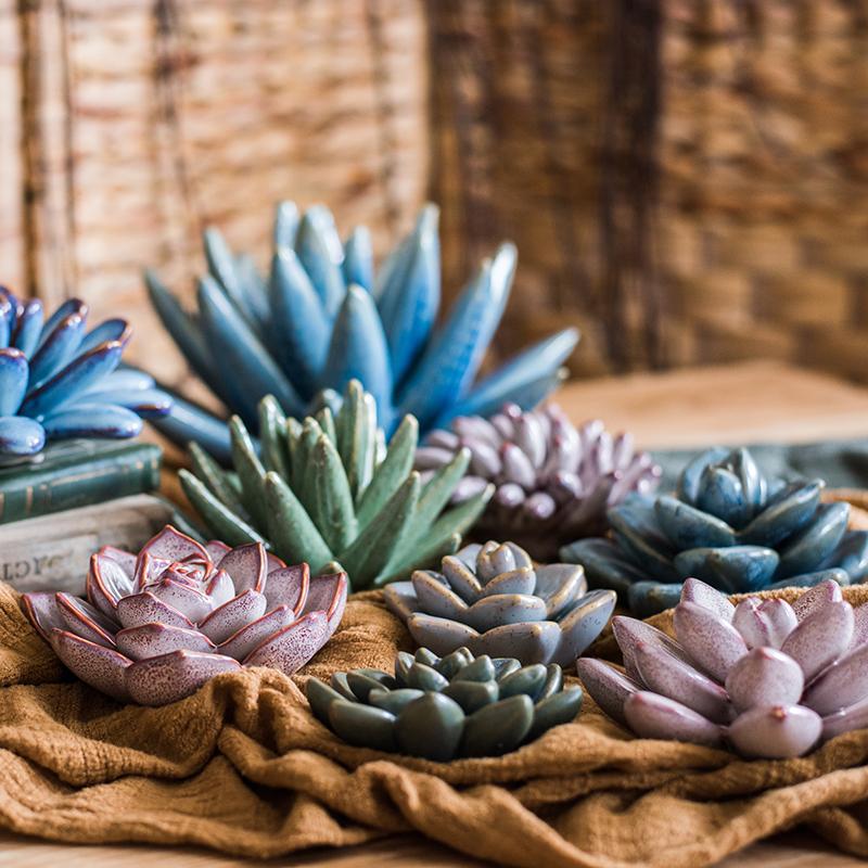 A collection of handmade ceramic floral table accents in various colors and sizes, showcasing their unique designs.