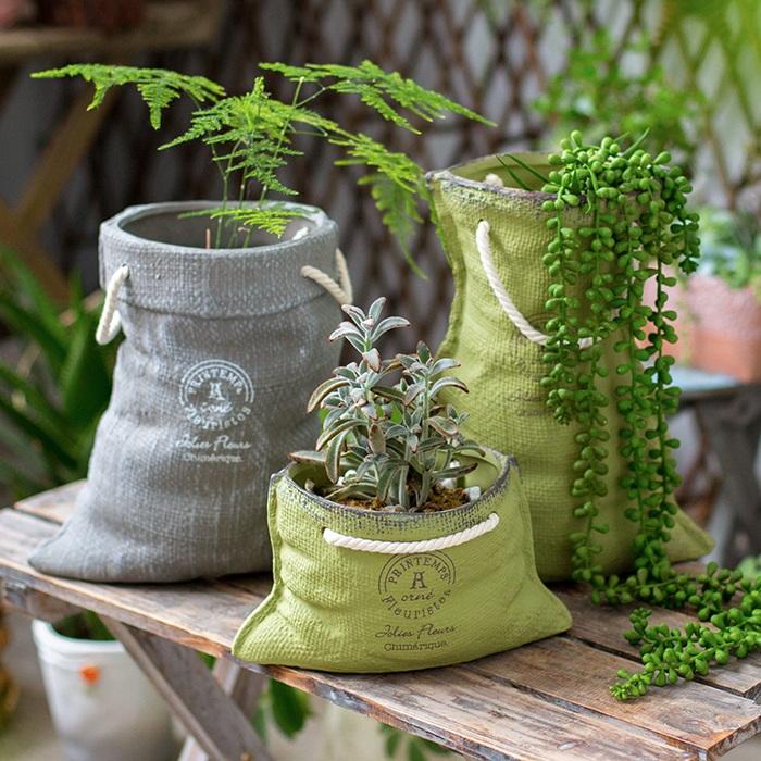 Ceramic planter with linen bag design in green and gray, showcasing its elegant shape and texture.