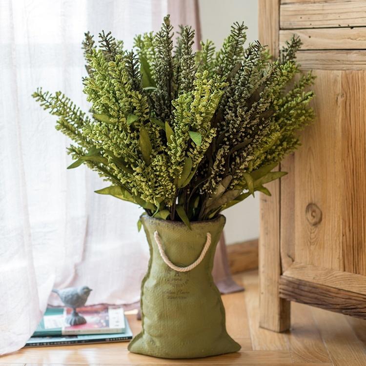 Ceramic planter with linen bag design in green and gray, showcasing its elegant shape and texture.