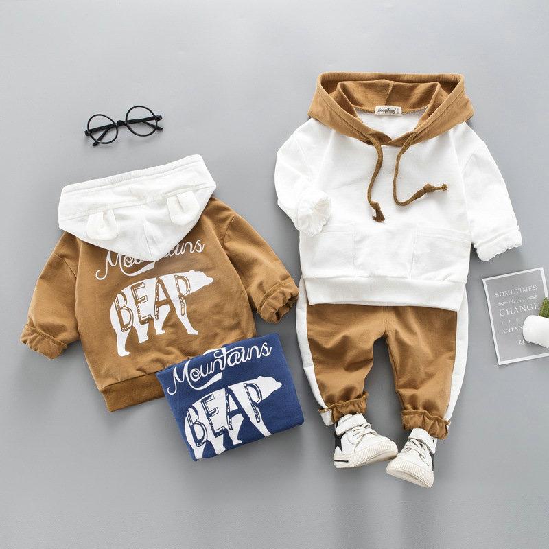 A stylish toddler girls' clothing set featuring a hooded top and pants, made from 100% cotton, perfect for spring and autumn wear.