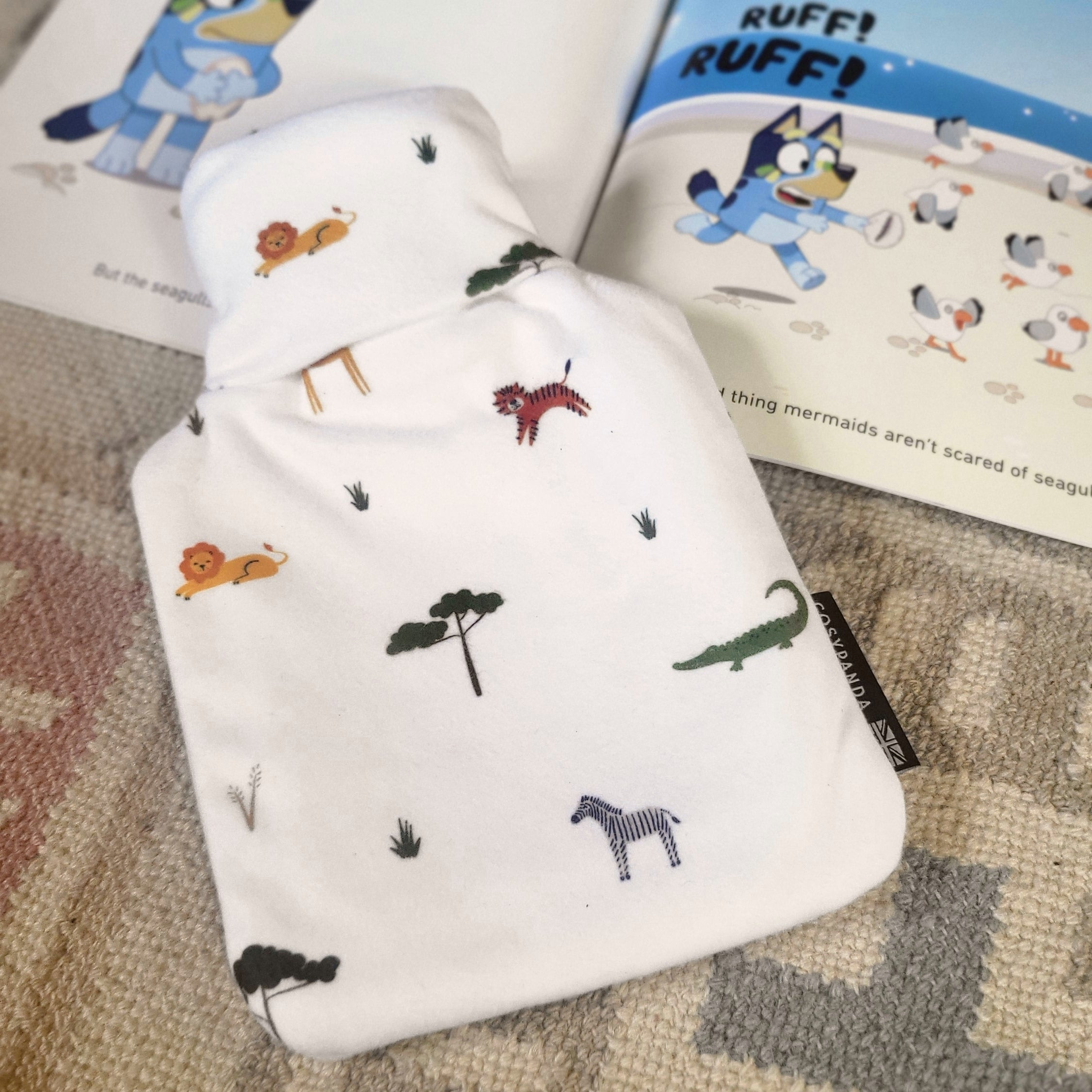 Children’s Safari Print 1L Hot Water Bottle with a soft cover featuring playful safari animals, designed for comfort and warmth.