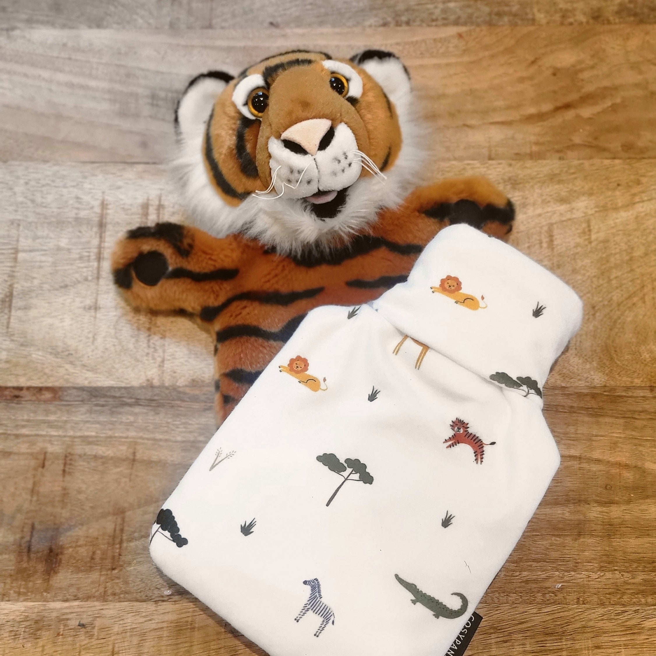 Children’s Safari Print 1L Hot Water Bottle with a soft cover featuring playful safari animals, designed for comfort and warmth.