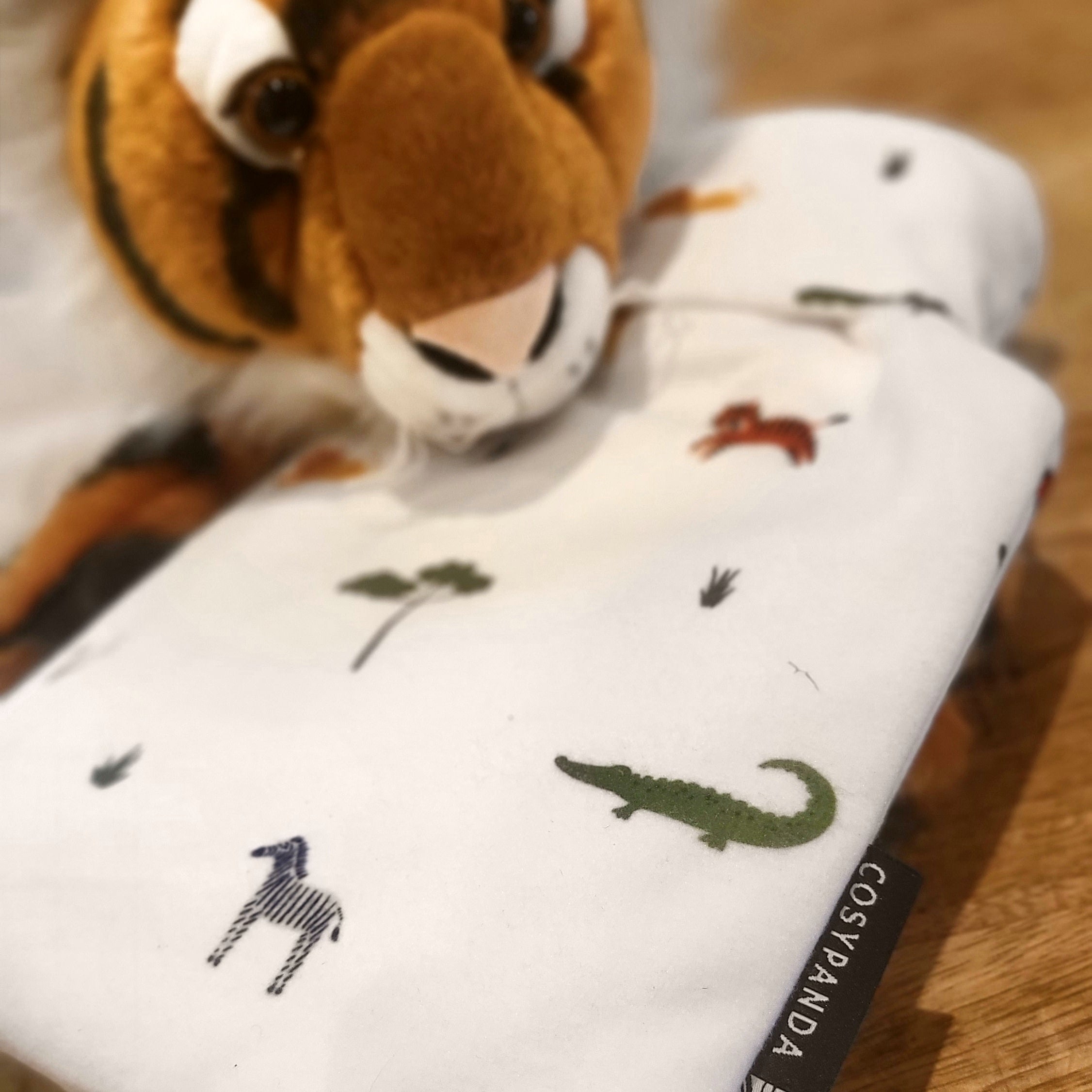 Children’s Safari Print 1L Hot Water Bottle with a soft cover featuring playful safari animals, designed for comfort and warmth.