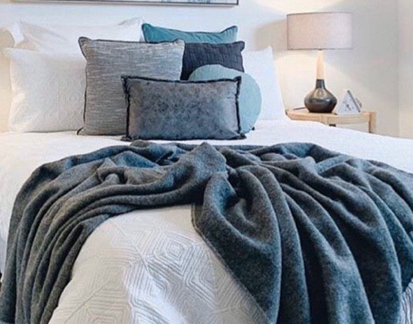 Chiswick Throw blanket made from Merino wool and cashmere in charcoal color, showcasing its luxurious texture and elegant design.