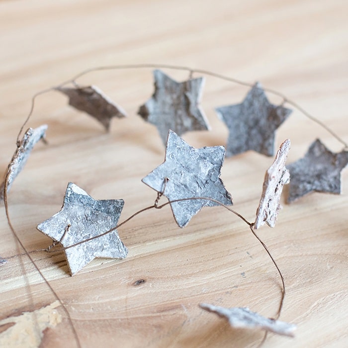 Christmas Decorative String featuring various shapes like maple leaves and pine cones, perfect for festive holiday decor.