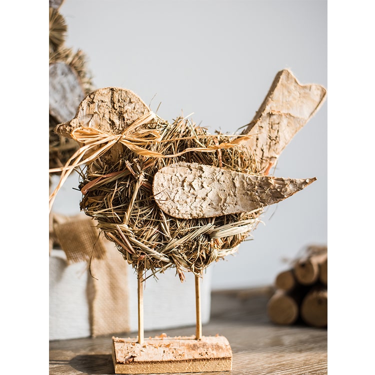 A collection of rustic Christmas figurine decorations including a hen, owl, rabbit, and flowers, crafted from natural wood and straw.