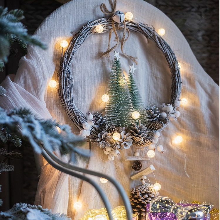 Rustic Christmas wreath made of natural rattan and pine cones, perfect for holiday decoration.