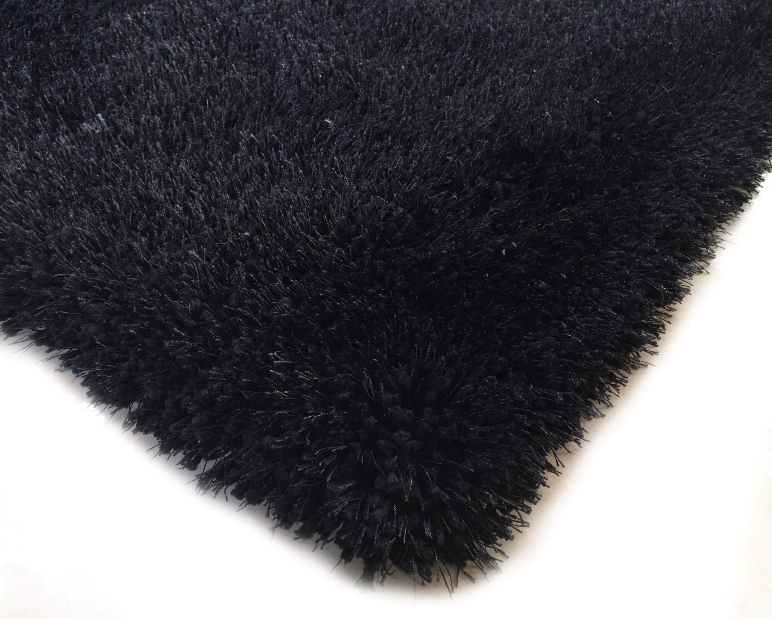 Chubby Black Area Rug featuring a soft shaggy texture, hand tufted design, and cotton backing, available in two sizes.